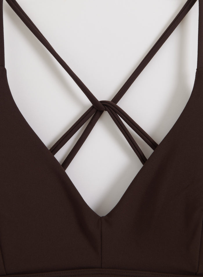 Decorative criss-cross back straps on a chocolate brown aim'n Sense Strap Bra with a soft second skin feel.