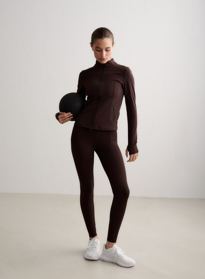 Chocolate brown aim'n Sense Tall Tights and matching jacket worn by a model holding a fitness ball. [S-174cm]