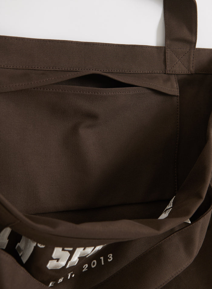 Inner slip pocket detail of a chocolate brown cotton canvas Varsity Tote Bag from aim'n.
