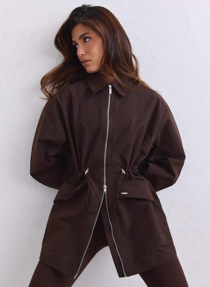 Chocolate aim'n Waterproof Zip Jacket featuring a two-way zipper and adjustable cinched waist. [S-165cm]