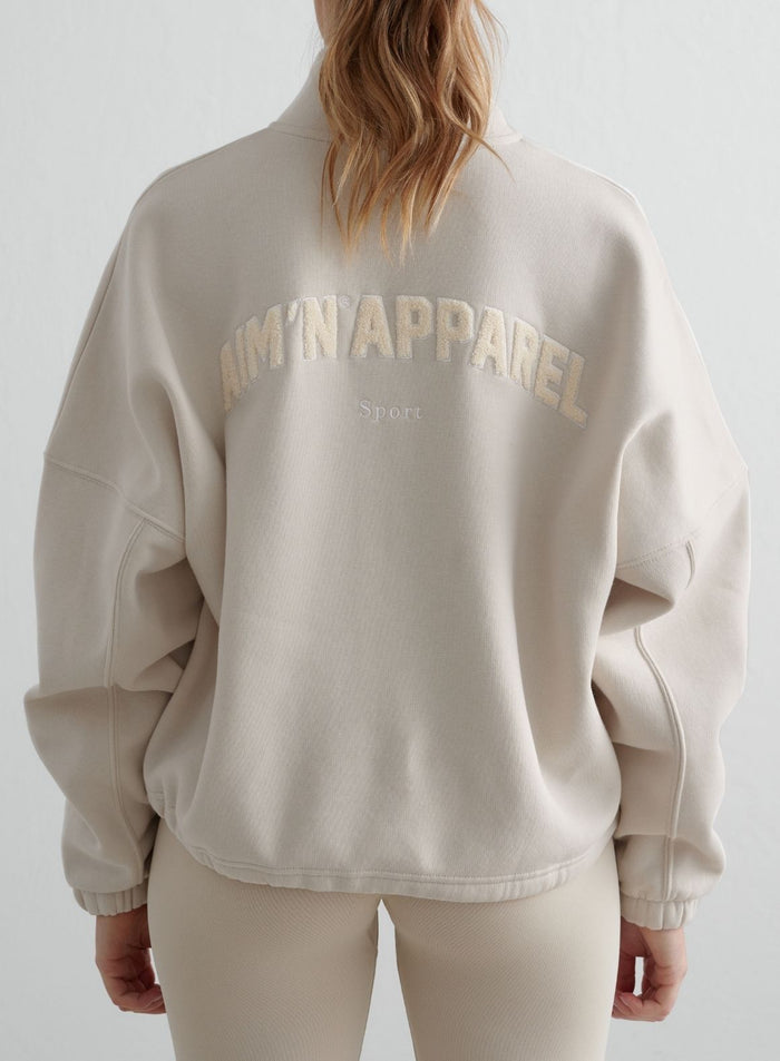 Back view of the clay Campus Sweat Zip Jacket from aim'n, featuring textured teddy artwork for a cozy look.