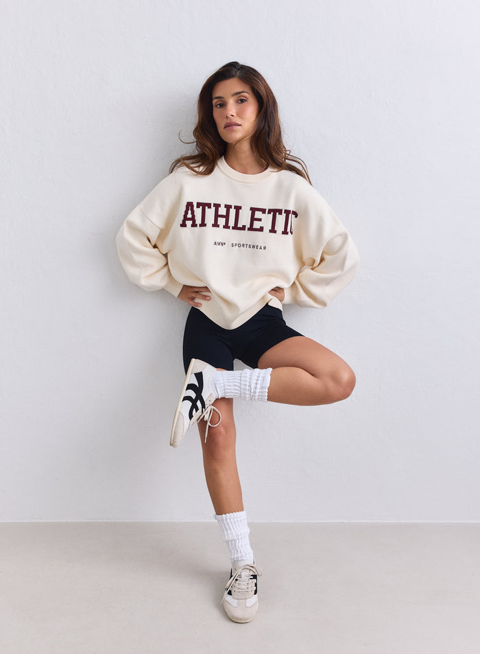 Oversized cream aim'n Athletic Knit Sweatshirt with burgundy lettering paired with black shorts. [S-165cm]