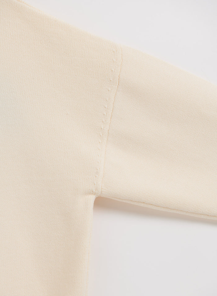 Cream Athletic Knit Sweatshirt by aim'n featuring a close-up of the soft knit fabric and shoulder seam.