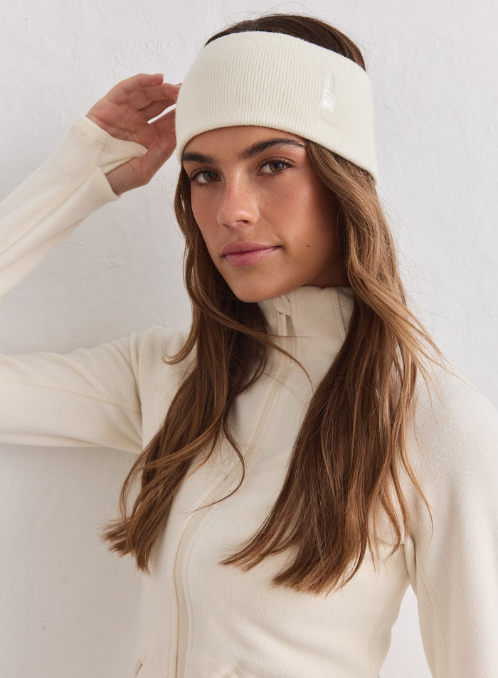 Cream ribbed aim'n Outdoor Logo Headband worn by a woman with a matching fleece jacket.