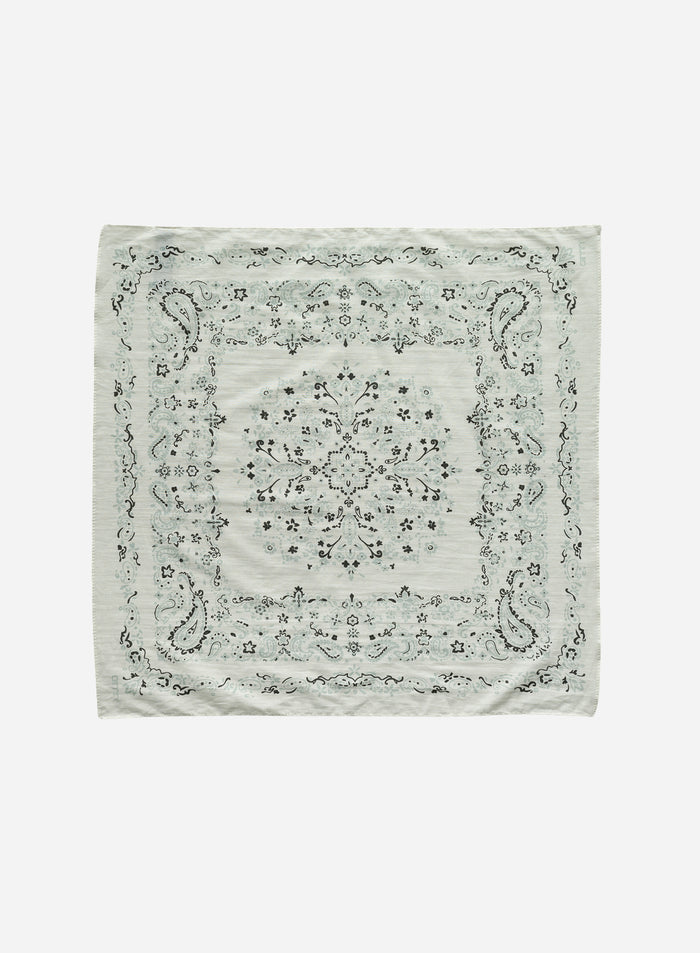 Cream outdoor scarf with a patterned paisley design shown in a flatlay