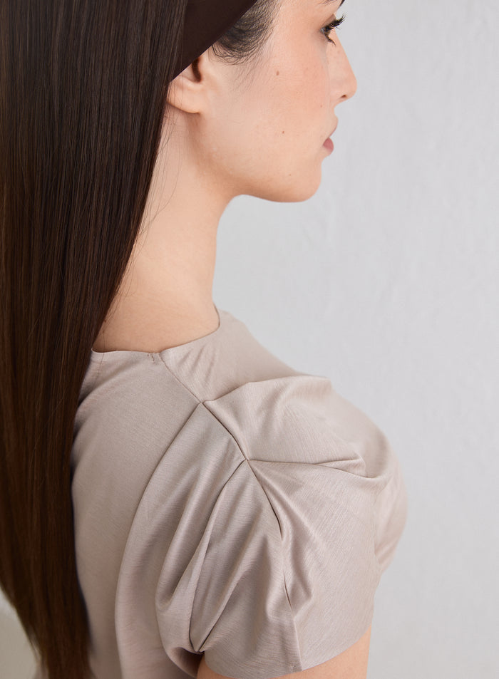 Side profile of a woman wearing a Dark Clay Luminous Draped Short Sleeve [L-174cm]