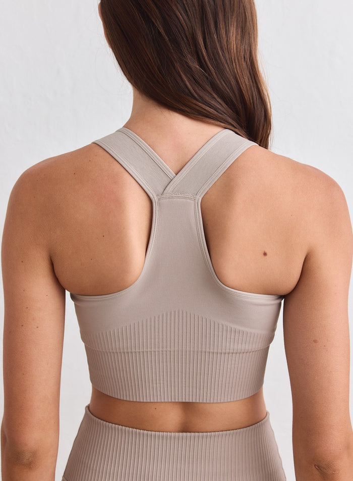 Back view of a Dark Clay ribbed seamless high support racerback bra by aim'n. [xs-178cm]