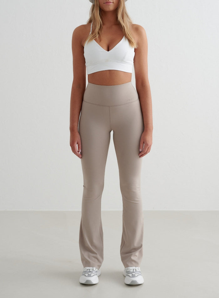 Dark Clay aim'n Sense Flare Tights with a high waist, flared leg, and squat proof second skin feel.