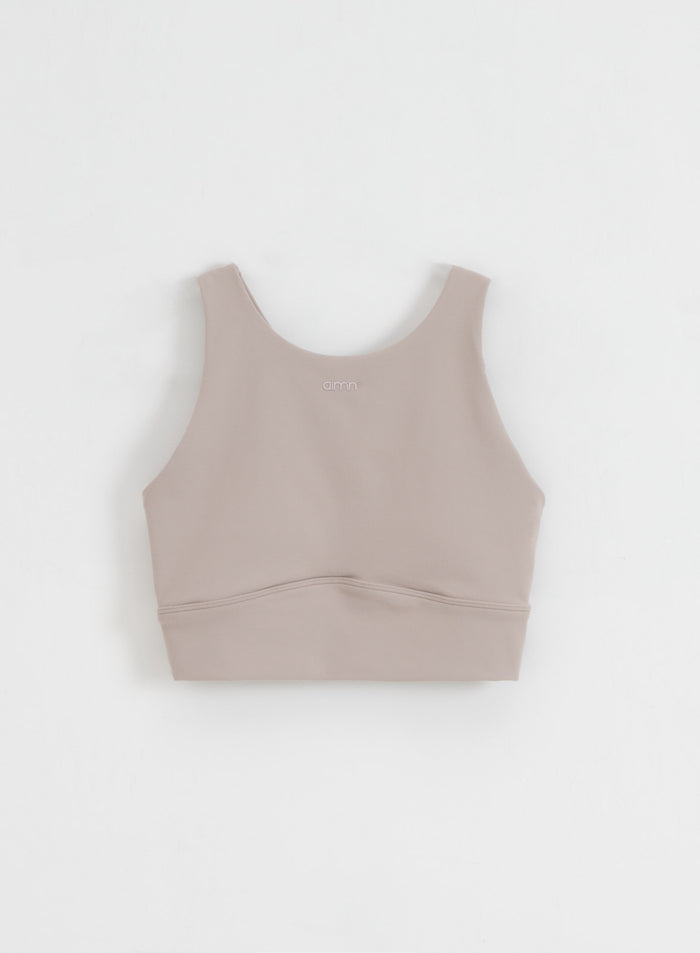 Dark clay aim'n Sense Sports Bra with a high neckline and soft brushed fabric, shown in a flatlay.
