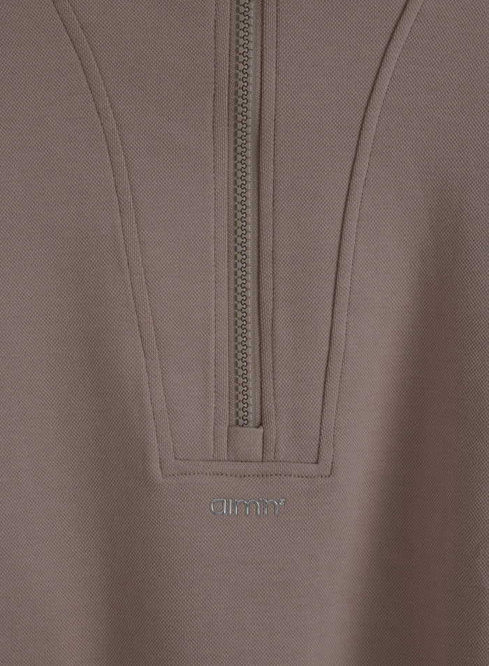 Dark clay Sportif Half Zip Hood featuring structured jersey, a half-zip, and a metallic aim'n logo.