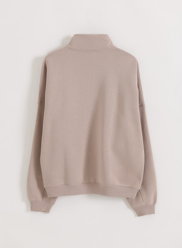 Dark clay varsity sweatshirt by aim'n, shown from the back with a stand collar and ribbed hem.