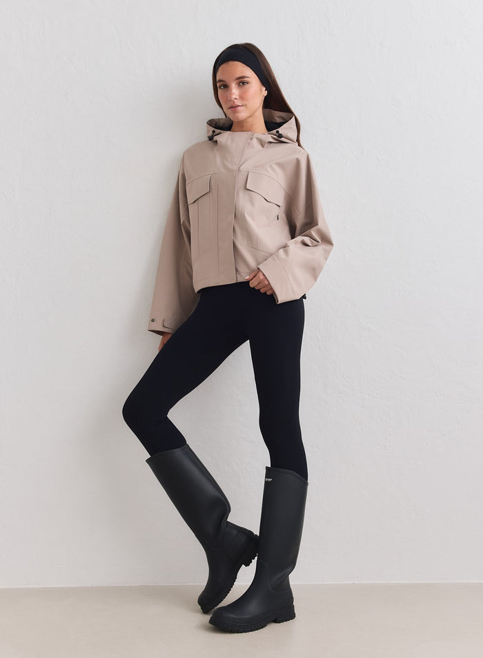 Dark clay aim'n Waterproof Jacket with cargo pockets, black leggings and tall rain boots. [M-178cm]