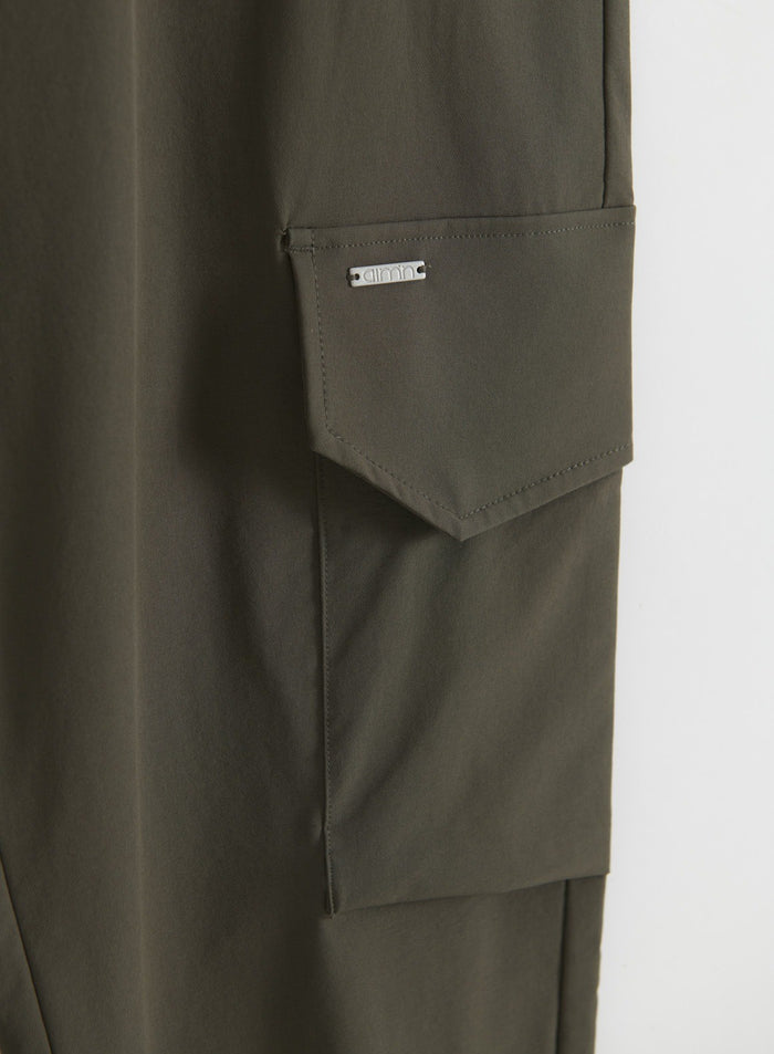 Close-up of Dark Ivy cargo pants with flap cargo pocket and aim'n logo