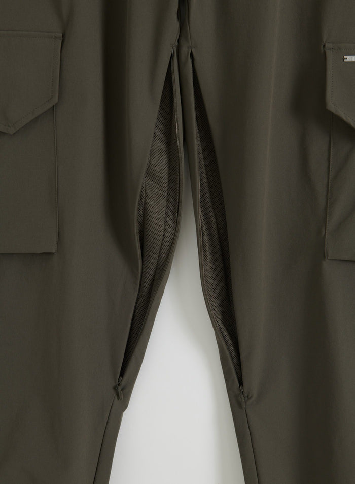 Close-up flat lay of dark ivy cargo pants with cargo pockets and mesh ventilation zips