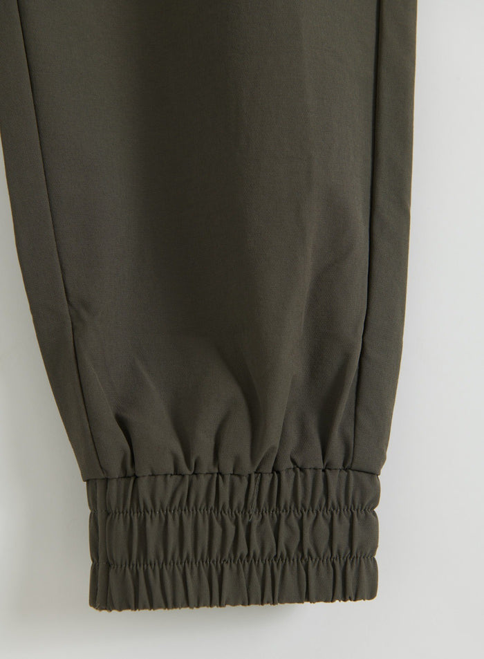 Close-up of Dark Ivy cargo pants leg with a gathered elasticated ankle cuff