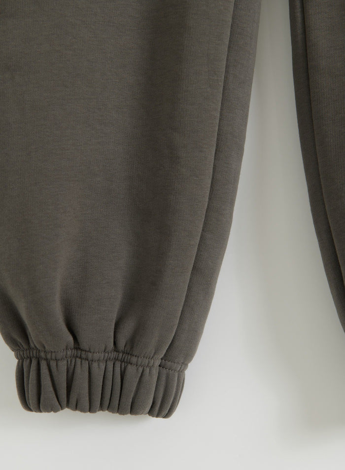 Close-up of the cuffed ankle and soft fabric of Dark Ivy sweatpants