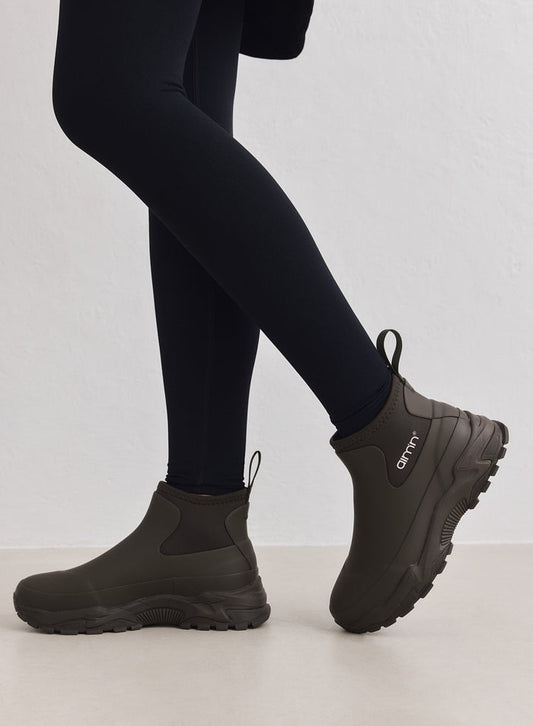Dark Ivy Chelsea-style Fusion Rain Boots by aim'n with chunky sneaker outsoles, worn with black leggings.