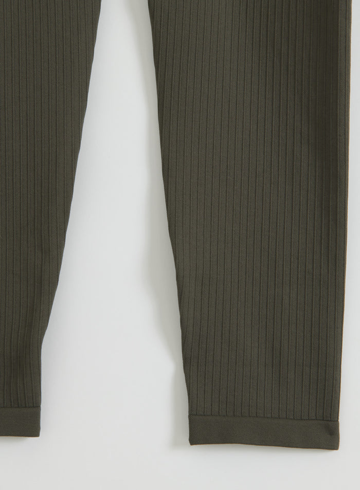 Close-up detail of the dark ivy ribbed seamless petite tights showing the texture