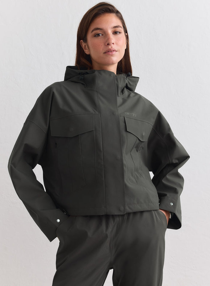 Dark ivy aim'n Waterproof Jacket featuring a cropped fit, cargo pockets, and adjustable hood. [M-178cm]