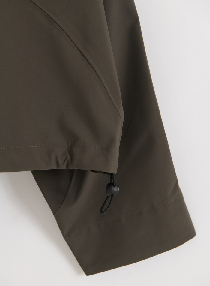 Close-up of the sleeve and hem detail with an adjustable drawstring on the Dark Ivy Waterproof Jacket