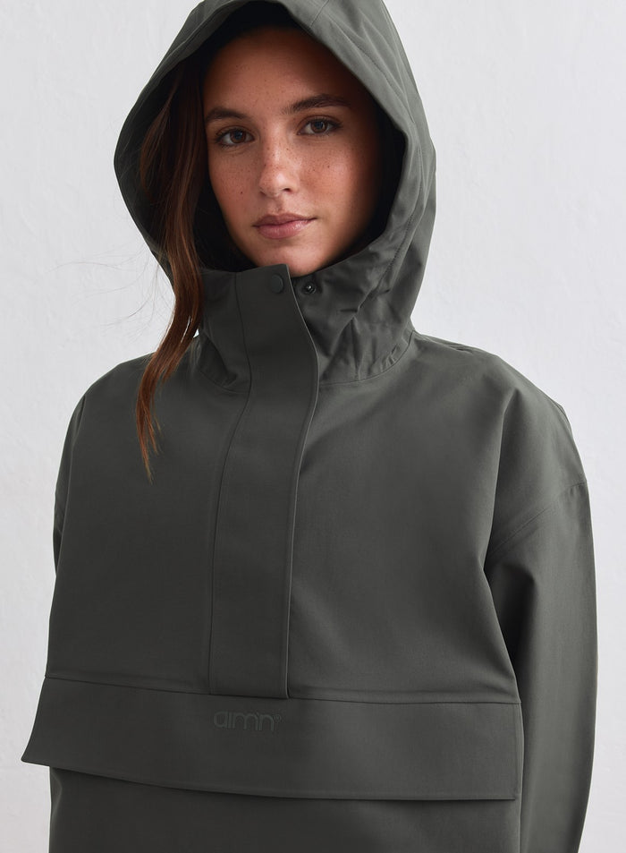 Dark ivy waterproof oversized anorak by aim'n with the hood up and half-zip detail. [M-178cm]