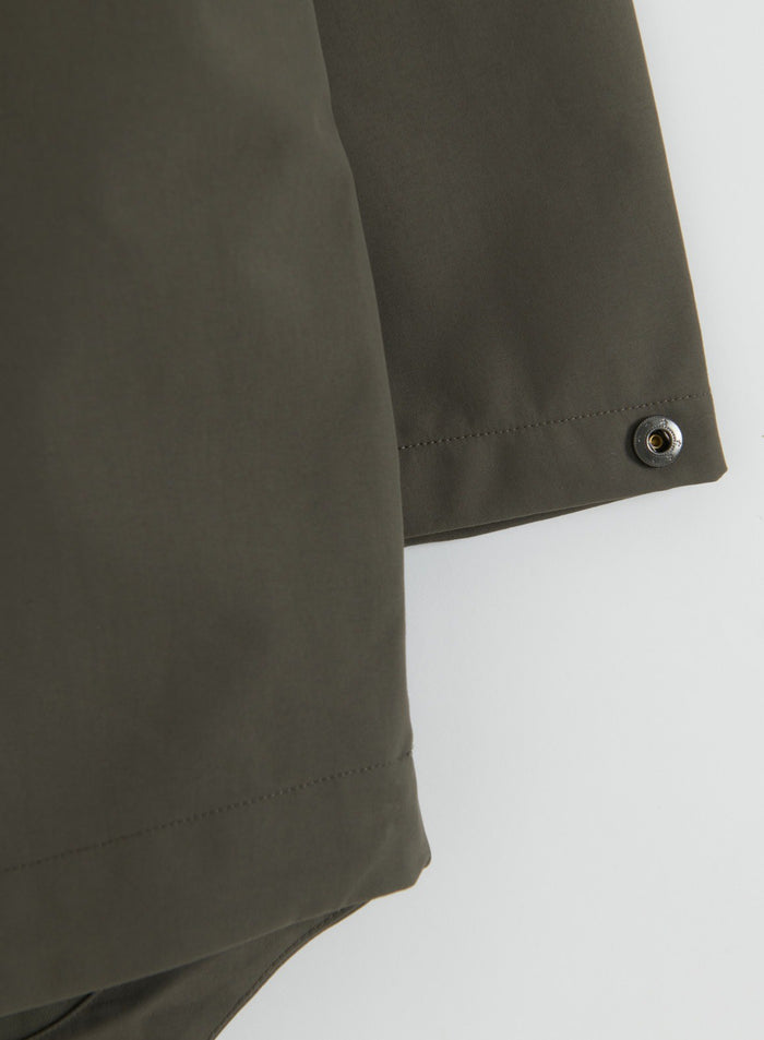 Close-up of the snap-adjustable cuff detail on the Dark Ivy Waterproof Oversized Anorak