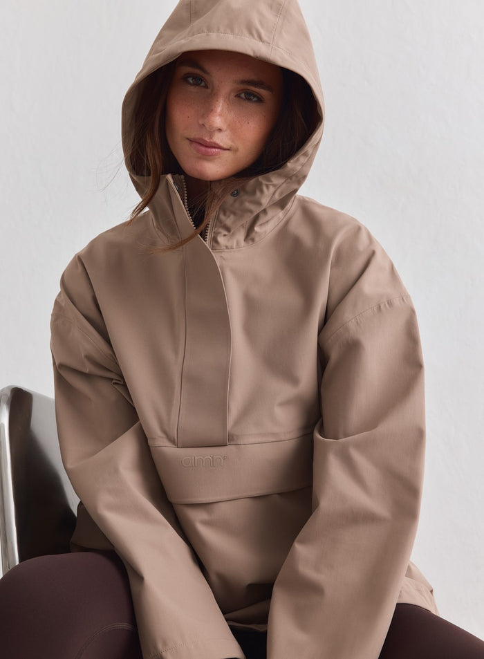 A model wearing the espresso Waterproof Oversized Anorak with the hood up [M-178cm]