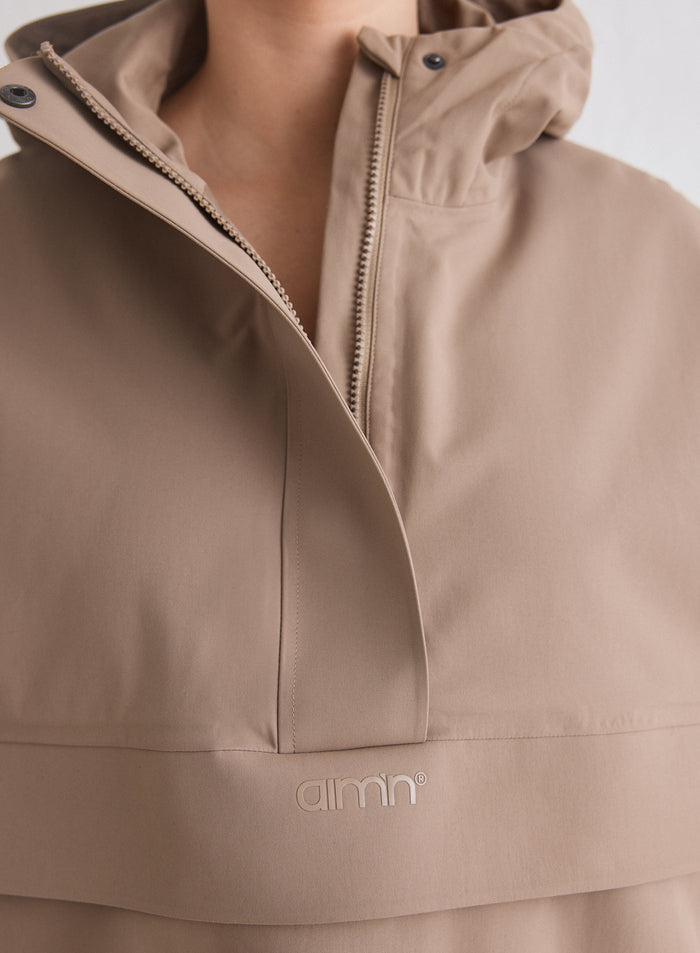 Close-up of the logo and zipper on the espresso Waterproof Oversized Anorak [M-174cm]