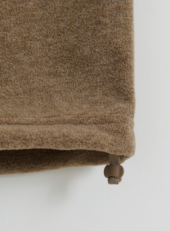 Close-up detail of the hem and adjustable drawstring on the hazelnut fleece pants