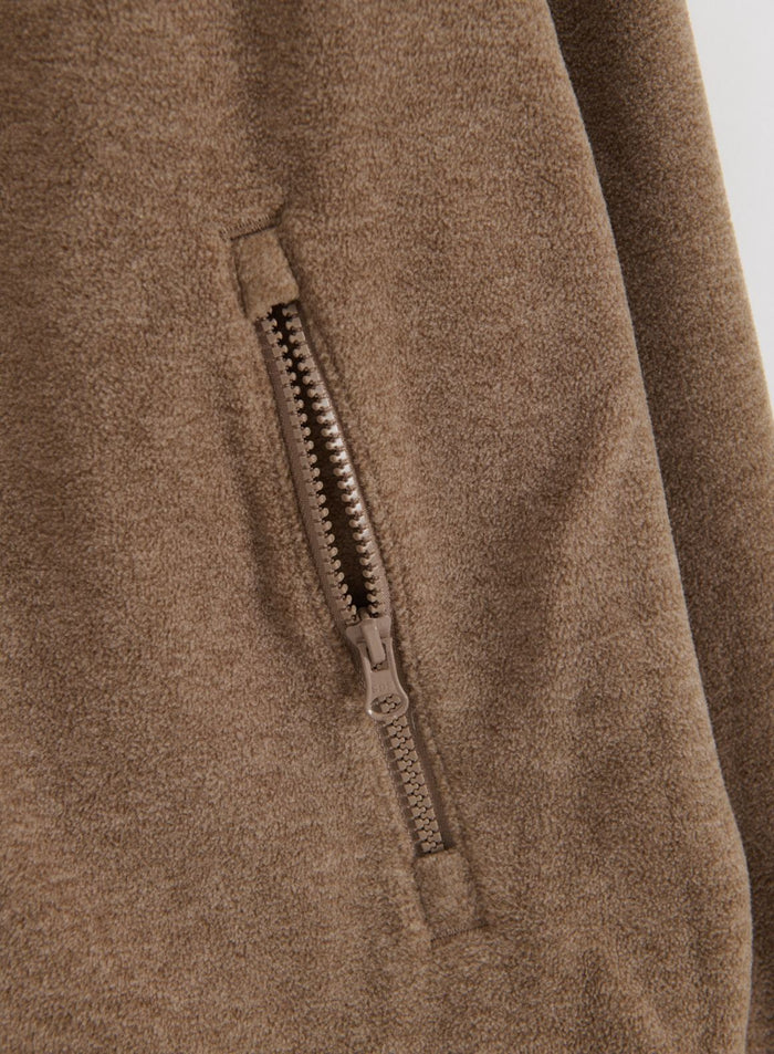 Close-up of the zipper pocket on the hazelnut fleece zip jacket