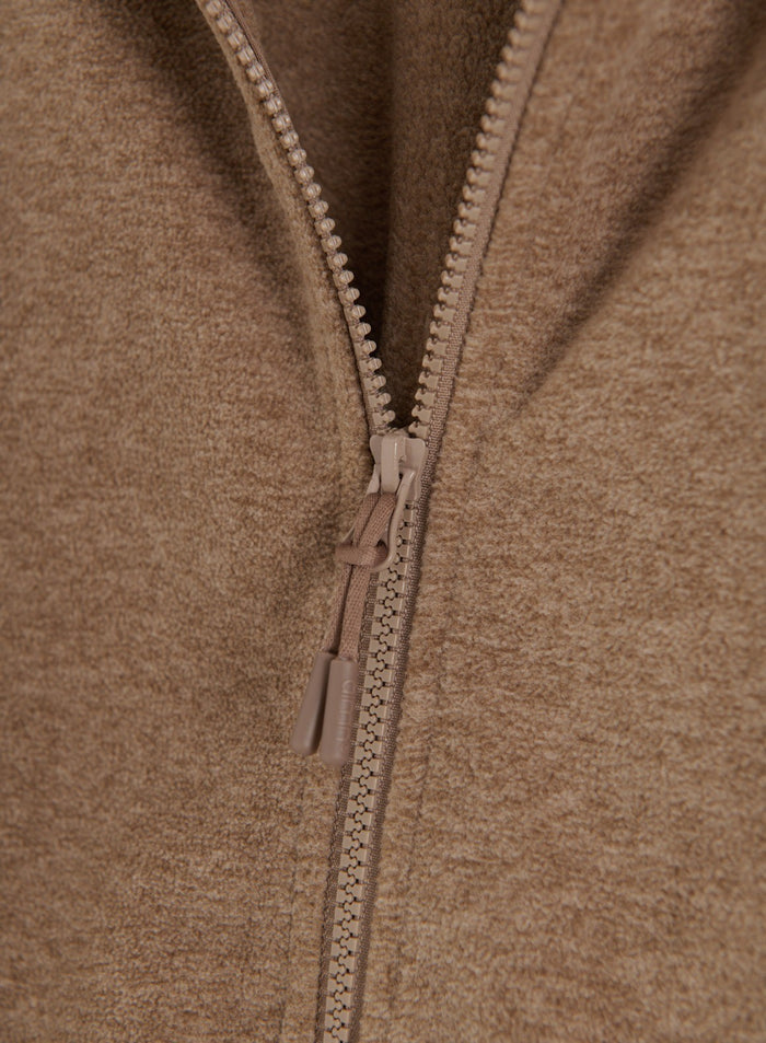 Close-up of the zipper and soft fleece fabric of the hazelnut fleece zip jacket