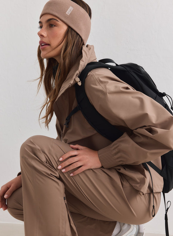 Ribbed hazelnut Outdoor Logo Headband by aim'n styled with a matching outdoor set and black backpack.