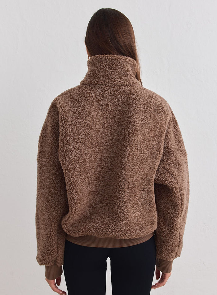 Hazelnut brown pile half zip from aim'n with a soft textured finish and ribbed cuffs, seen from the back. [xs-178cm]