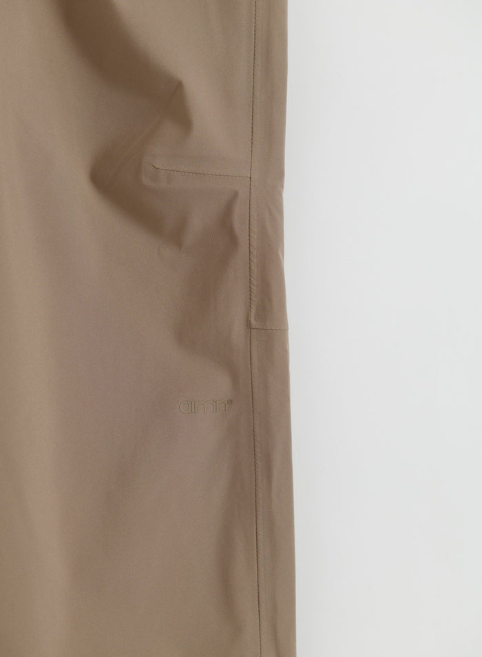 Close up of aim'n Hazelnut Waterproof Pants showing pocket detail and logo