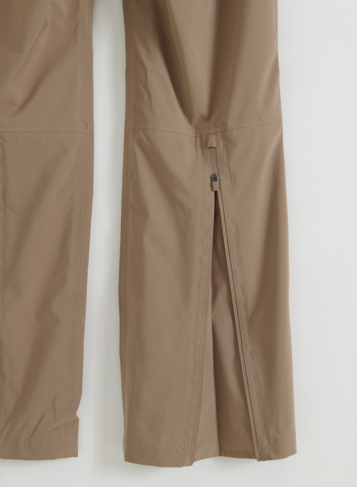 Flatlay of Hazelnut Waterproof Pants showing the adjustable calf zipper detail