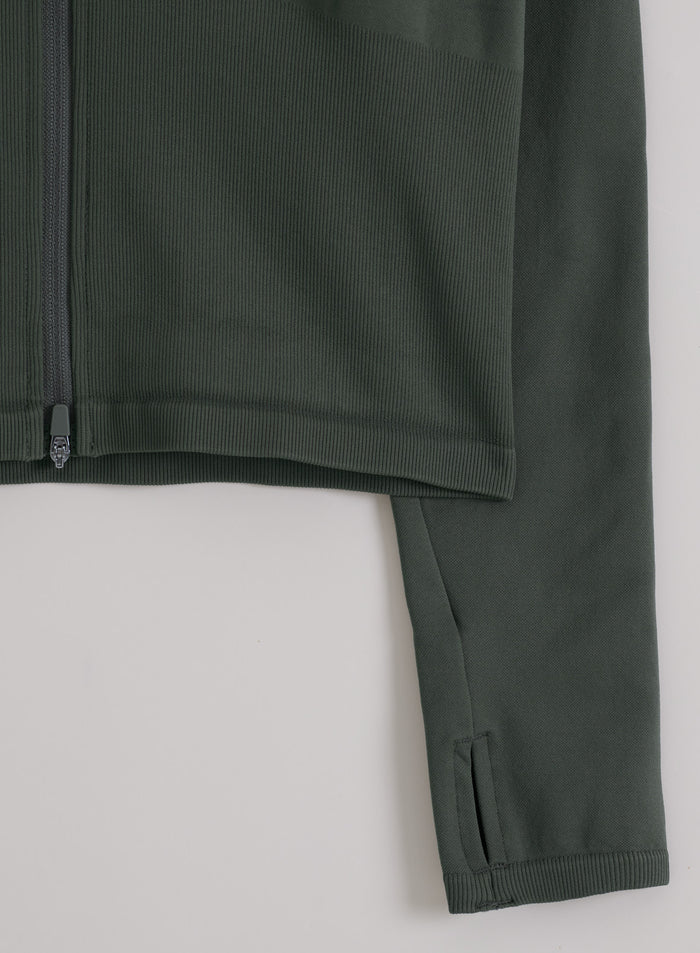 Ivy green aim'n Shape Seamless Zip Jacket featuring ribbed seamless fabric, a front zip, and sleeve thumbholes.