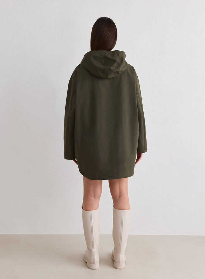 Back view of a person wearing a Khaki Waterproof Oversized Anorak and beige boots [M-174cm]