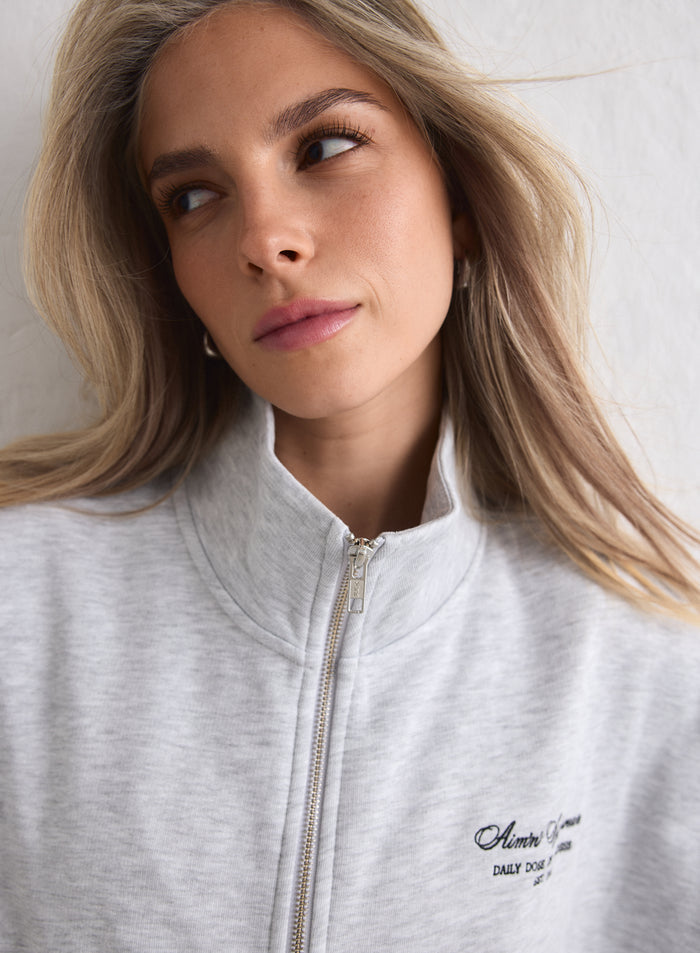 Close-up of a model wearing the Light Grey Melange Script Zip Jacket [M-170cm]