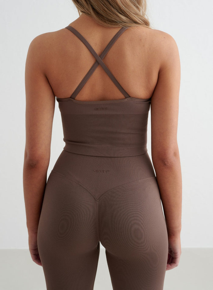 Macchiato Shape Seamless Cross Back Bralette and matching leggings by aim'n featuring a strappy back design.