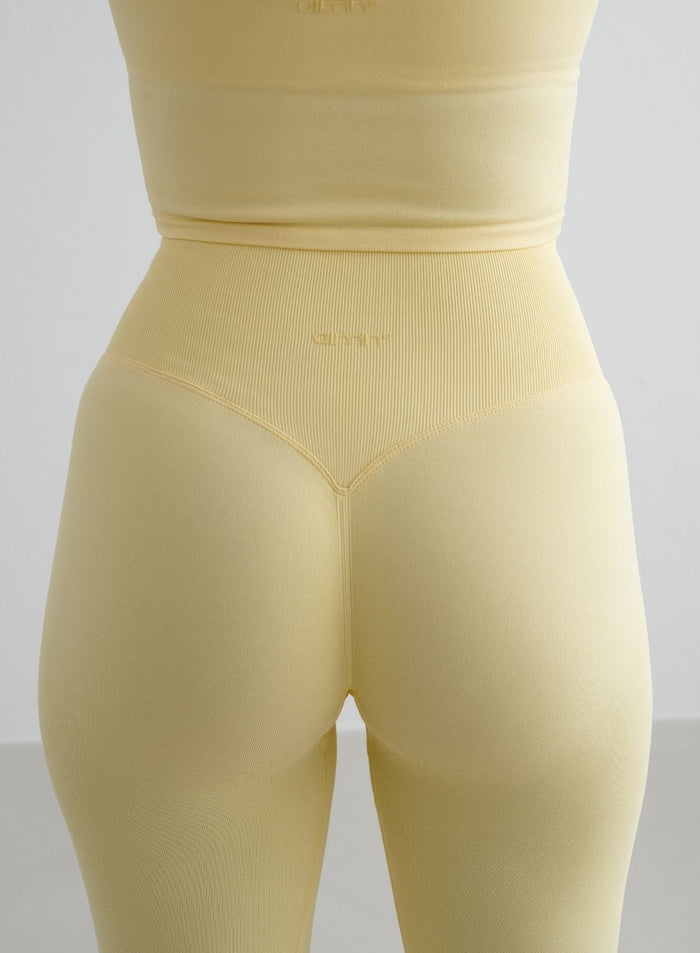 Yellow aim'n Shape Seamless Tights with a high ribbed waist, invisible scrunch, and tonal back logo.