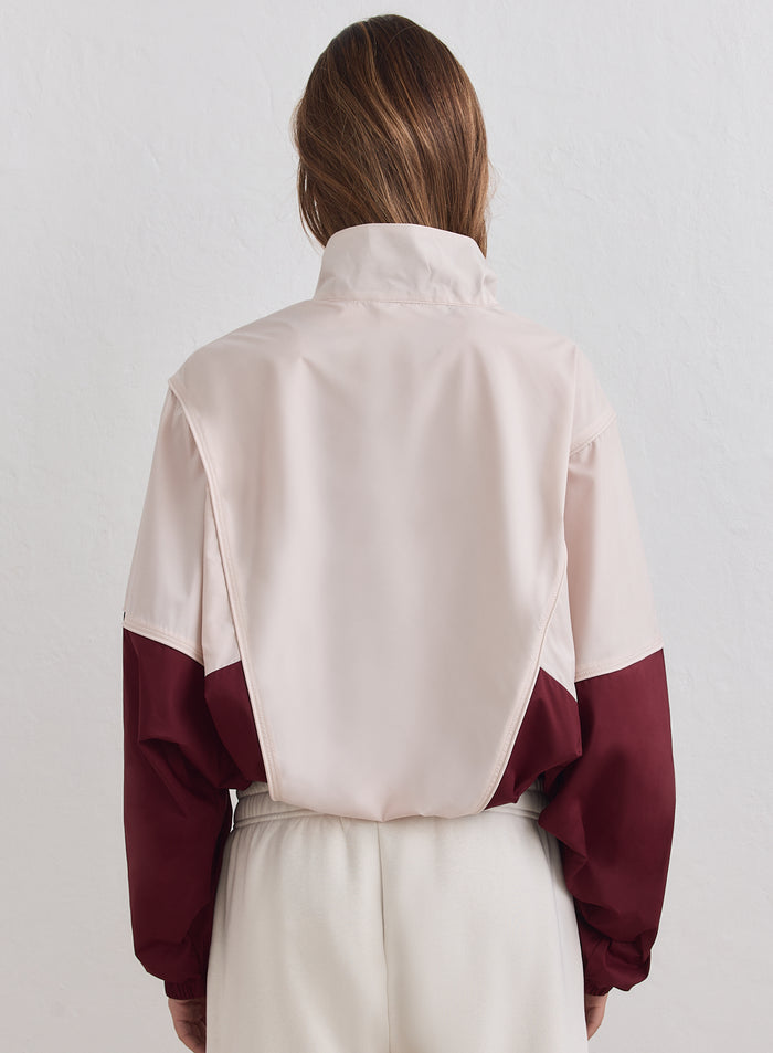 Merlot and beige Balance Windstopper Tracksuit Jacket by aim'n shown from the back with a loose fit.