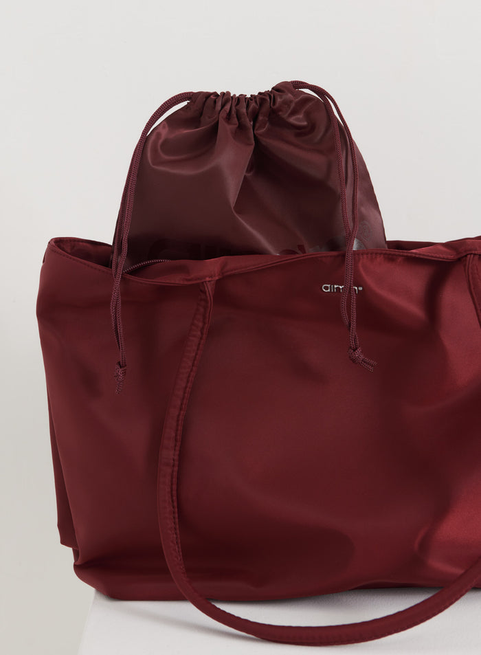 Merlot nylon tote bag by aim'n featuring a matching drawstring pouch.