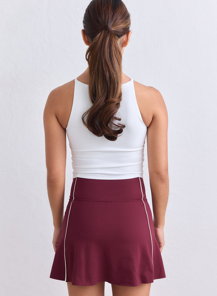 Merlot Sense Contrast Skort by aim'n featuring white piping and a sporty fit, back view. [XS-165cm]