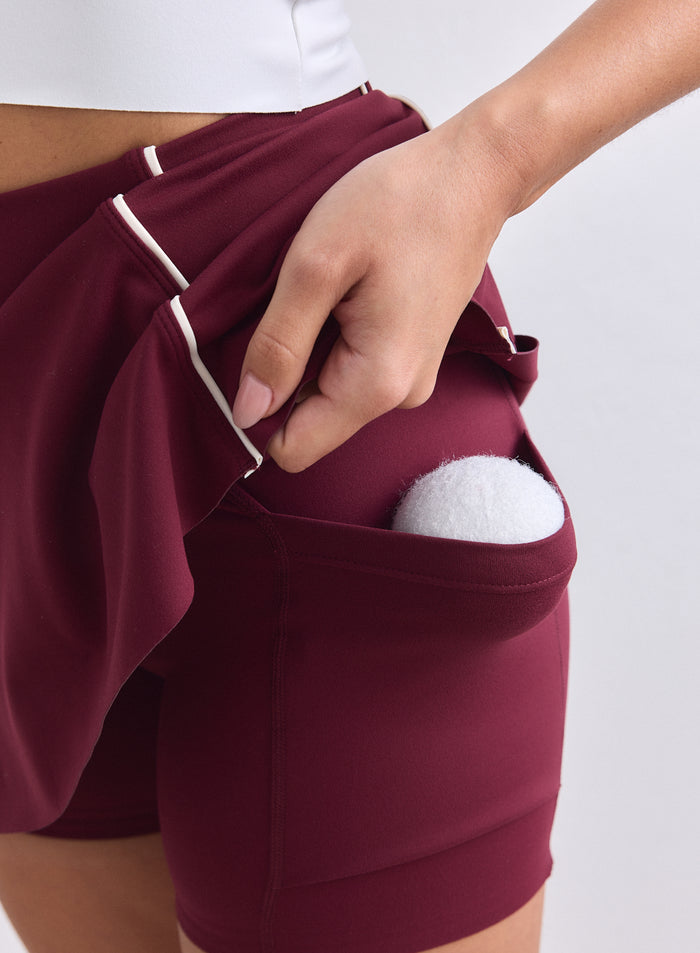 Merlot Sense Contrast Skort by aim'n featuring white piping and built-in shorts with a tennis ball. [XS-165cm]
