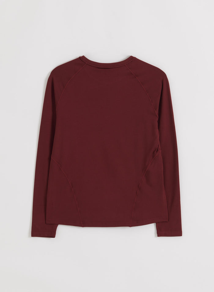 Back view flatlay of the merlot Soft Basic Long Sleeve by aim'n, featuring raglan sleeves and shaping details.
