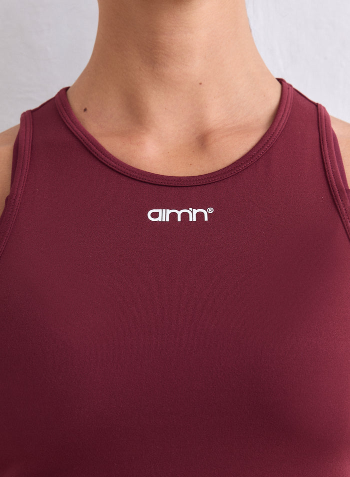 Merlot Soft Basic Singlet featuring a round neckline and a white aim'n logo. [S-165cm]