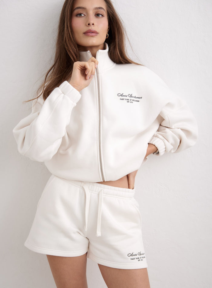 Off-white script sweat shorts by aim'n featuring a drawstring waist and soft jersey fabric. [XS-174cm]