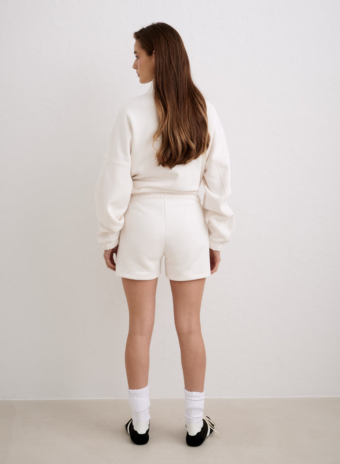 Rear view of a woman wearing off-white aim'n script sweat shorts and matching sweatshirt. [XS-174cm]