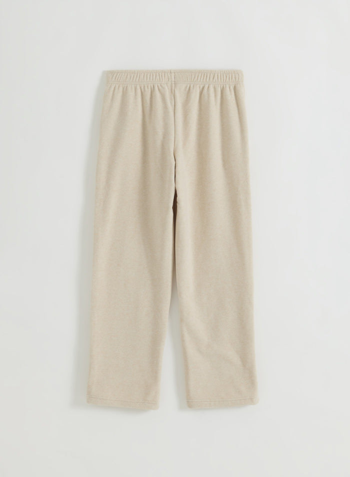 Sand fleece pants in flatlay from the back