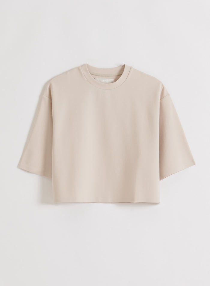 A sand-colored aim'n Luxe Boxy Short Sleeve top, laid flat [M-170CM]